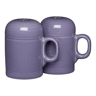 Two lavender ceramic shakers with handles, shaped like small mugs, sit side by side on a white background. The Fiesta Lavender 4 5/8 Inch Rangetop Large Salt and Pepper Shaker Set is made in the USA from lead-safe china.