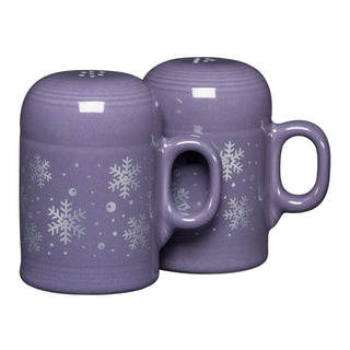 Two purple ceramic mugs with white snowflake patterns, made in the USA, pair perfectly with the Fiesta Lavender Snowflakes 4 5/8 Inch Rangetop Large Salt and Pepper Shaker Set.