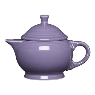 The Fiesta Lavender 2 Cup Teapot—a glossy, purple ceramic teapot with a rounded body, curved handle, short spout, and matching lid—is made in the USA, dishwasher safe, and displayed on a white background.
