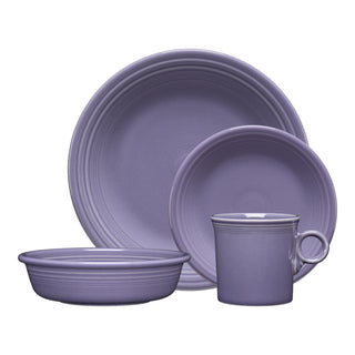 The Fiesta Lavender Classic Rim 4-Piece Place Setting includes a dinner plate, salad plate, bowl, and mug with ribbed edges and a glossy finish. This dishwasher-safe set offers classic style and convenience for one.