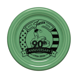 The Fiesta Meadow 90th Anniversary 4 3/8 Inch Coaster and Mug Cover features a woman in a dress, stars and stripes, exclusive green design, and is proudly made in the USA.