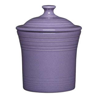 The Fiesta Lavender 13 OZ Mini Canister (5 5/8 Inch) is a purple ceramic container with horizontal ridges and a knob handle on its lid. Crafted from lead-safe china, this dishwasher-safe canister is shown isolated against a white background.