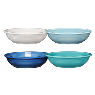 The Fiesta (FTC) Mixed Coastal Blues Classic Rim 8 3/8-Inch 34OZ Pasta Bowls set includes four ribbed ceramic bowls in white, light blue, dark blue, and turquoise—dishwasher safe and ideal for your next pasta night.
