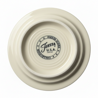Cream-colored ceramic plate seen from above, featuring the Fiesta Icons Collection bottom stamp with "Fiesta U.S.A. Lead Safe" in black and stars. Perfect companion to Fiesta Icons Disk Pitcher and Salt and Pepper set or 4 3/8 inch Coaster and Mug Covers.
