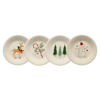 Bring cheer to your table with the Fiesta (FTC) Jolly Christmas Classic Rim 9 Inch Luncheon Plate Set of 4, featuring festive designs: reindeer in a scarf, candy cane with pine, three Christmas trees, and a smiling snowman.
