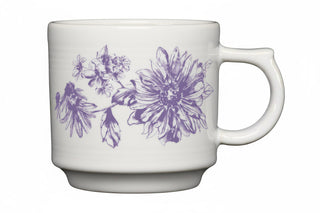 The Fiesta Botanical Floral Lavender 16oz Stackable Mug is a white ceramic mug with a handle, featuring a purple floral design, part of our Botanical collection. Beautifully crafted and made in the USA.