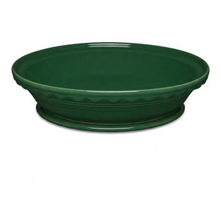 A deep, dark green Fiesta Factory Direct Pie Baker and Trivet with a scalloped edge and matching extra large trivet.