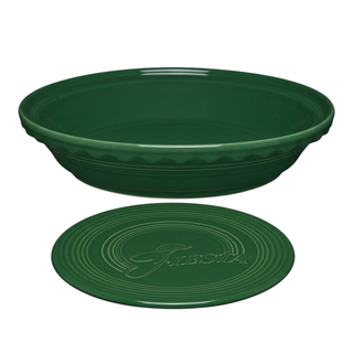 A deep green Fiesta Factory Direct Pie Baker and Trivet featuring a deep-dish design with a fluted rim and a matching extra large trivet.