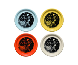 Four decorative plates with skeleton designs on a white background