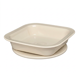 Off-white Square Baker and Trivet with the square baking dish resting on its matching circular trivet.