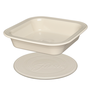 A Square Baker and Trivet consisting of a square ceramic baking dish positioned above a matching round ceramic trivet.