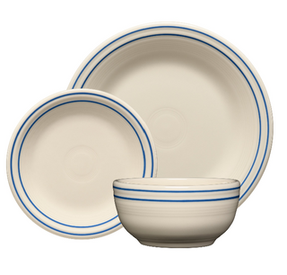 The Fiesta Americana Lapis Band Set includes four 7¼-inch white ceramic salad plates with subtle concentric circles and a blue rim. Made in the USA.
