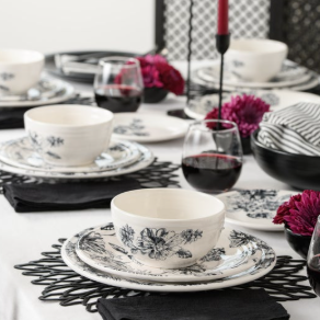 A dining table set with Fiesta Factory Direct's Botanical Floral Black Classic Bistro 3-piece Place Setting, Service for 1, featuring floral dishes and black accents, creates an elegant and modern bistro atmosphere.