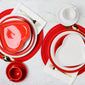 Scarlet and White heart plates with gold silverware on regular plates and a white table